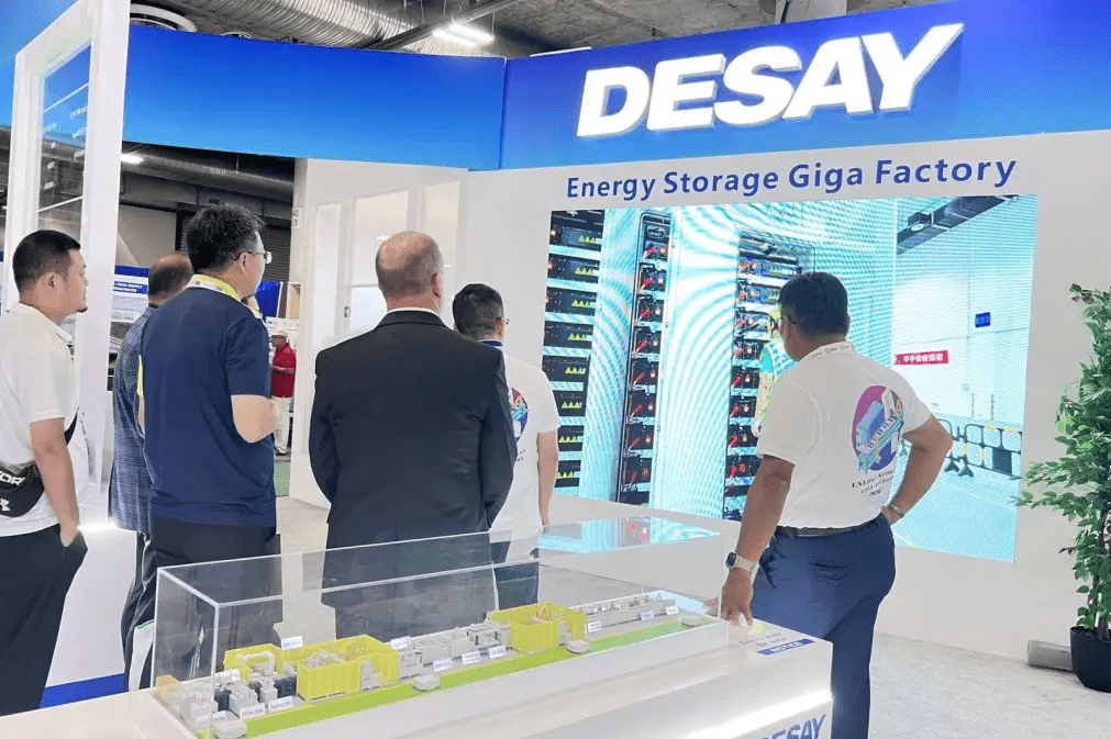 Visitors check up on Desay's display.