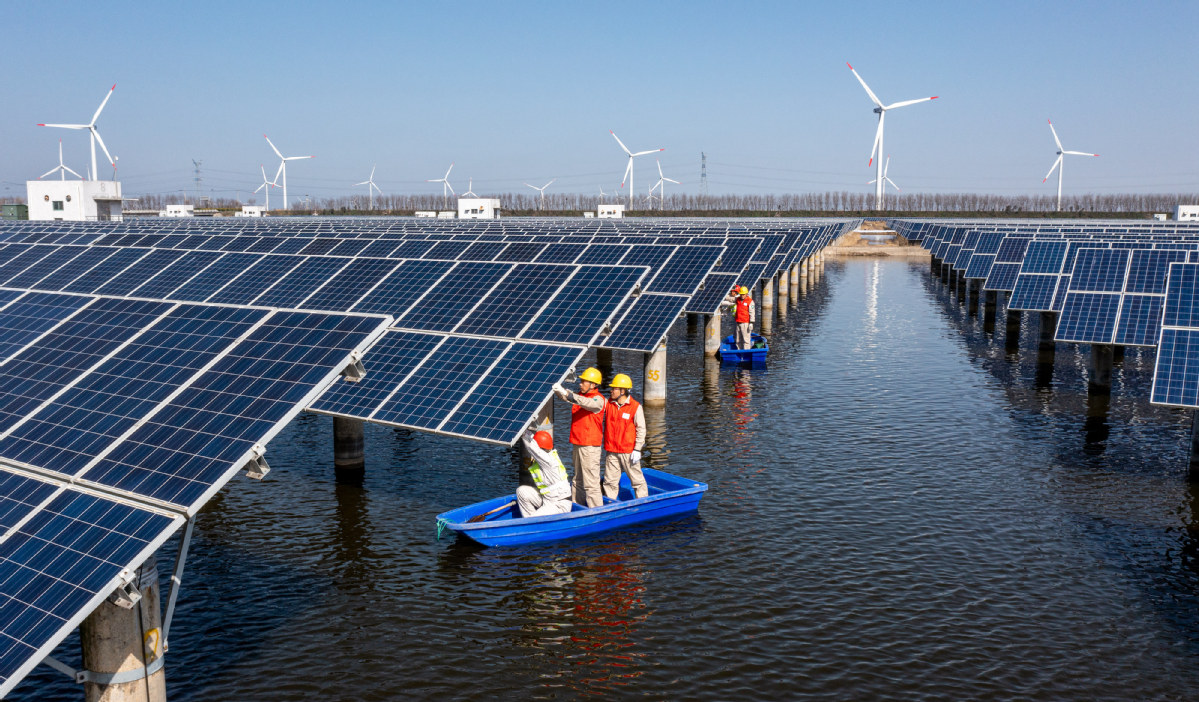 Workers inspect photovoltaic power generation facilities in Hai'an, East China's Jiangsu province, on March 15, 2022. Photo-IC.jpeg